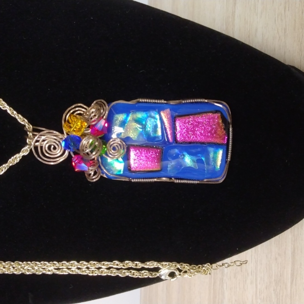 Beautiful artistic pendant on long silvertone chain pink and blue